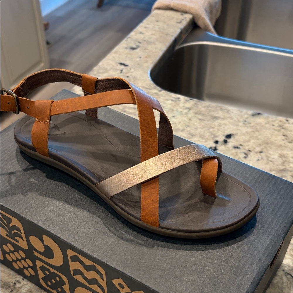 OluKai Women's Strappy Sandal in Brown and Metallic